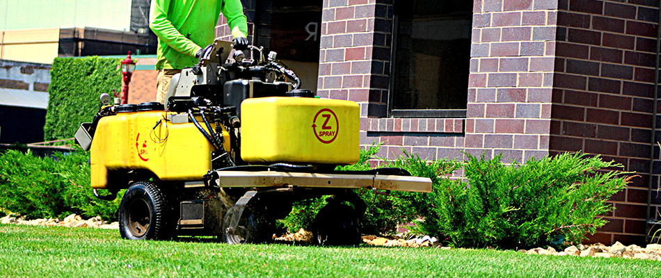 A technician servicing lawn in Janesville, MN.
